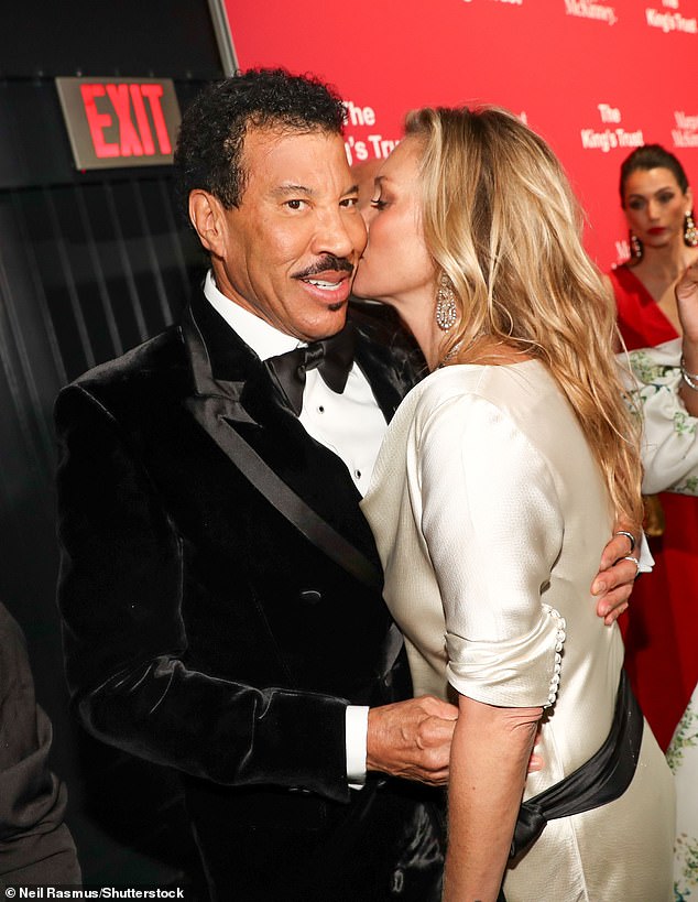 The supermodel planted a kiss on the cheek of the driver Lionel during the event