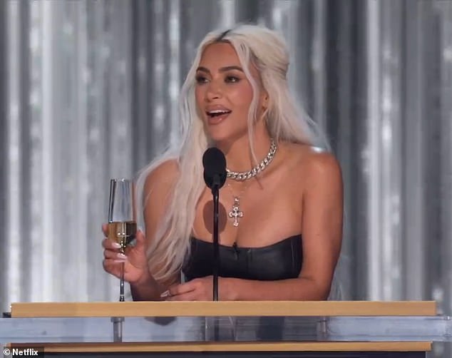 Kardashian sported blonde locks while holding a glass of champagne at the event in Southern California.