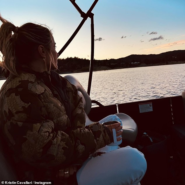 She watched the sun set behind the mountains from the boat.