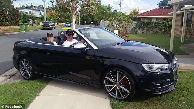 The former police officer poses in his black Audi convertible in November 2016.