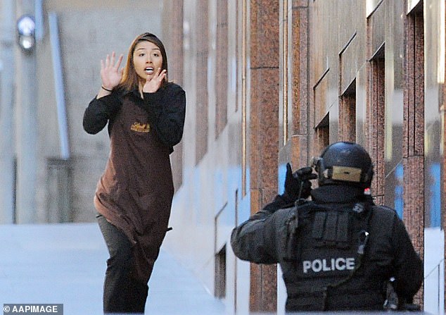 Sydney Siege hostage Elly Chen flees the Lindt cafe in Martin Place, Sydney, Monday, December 15, 2014.