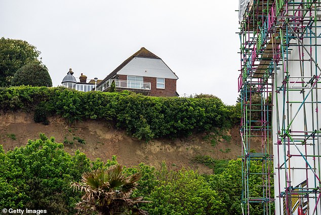 Following a landslide, a road in Folkestone was closed, with the house above pictured.