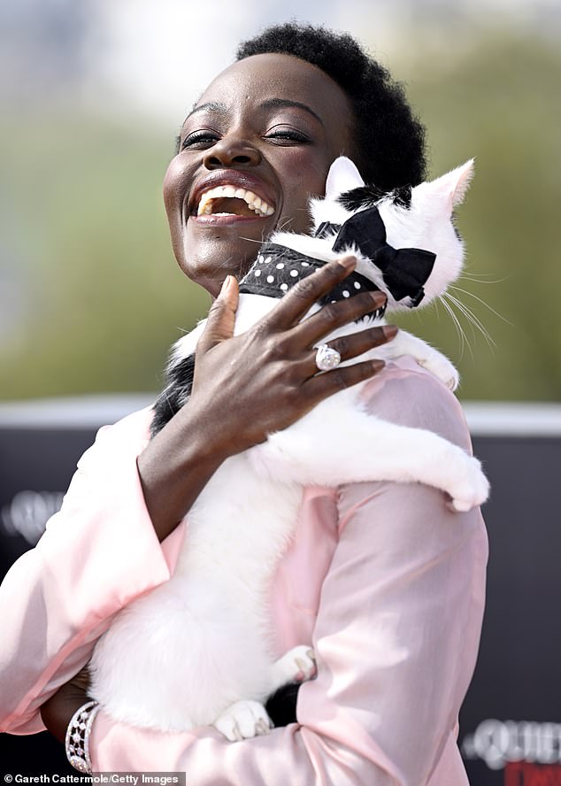 Lupita Nyong'o put on a spirited display as she posed with a cat while attending the photocall for her new film A Quiet Place: Day One.