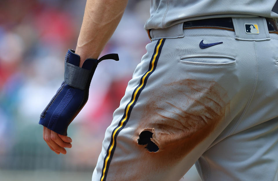 ATLANTA, GEORGIA – JULY 30: Christian Yelich #22 of the Milwaukee Brewers reacts after putting a hole in his pants with a slide while advancing to third base on a single by William Contreras #24 in the first inning against the Braves of Atlanta at Truist Park.  on July 30, 2023 in Atlanta, Georgia.  (Photo by Kevin C. Cox/Getty Images)