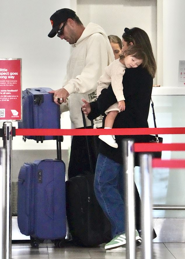 Matt looked smitten as he walked alongside his new love, who was carrying their sleeping baby ahead of their flight to Sydney.