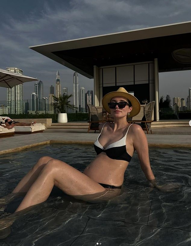 The former TOWIE star, 31, struck a confident pose while sitting in a shallow pool as she updated her followers on how the pregnancy was going and said the baby is now 