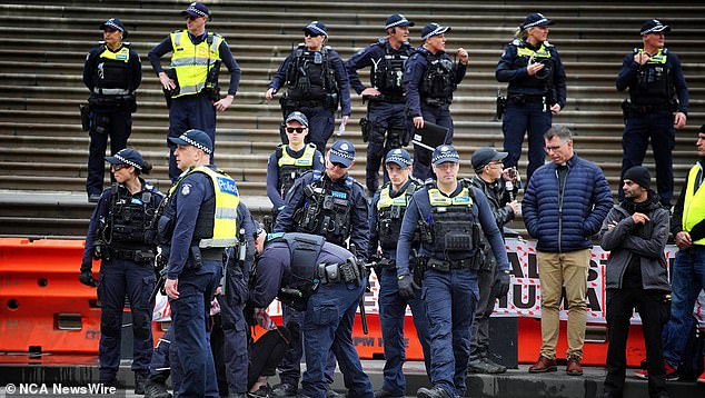 Victoria Police formed a barrier to help prevent violence as the Nakba rally that began around midday met the Never Again is Now rally in the Melbourne CBD (pictured).