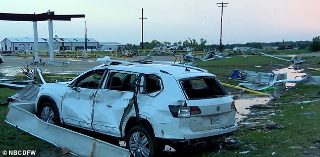 A car at the gas station is severely damaged by the tornado