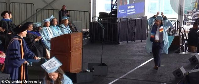 During Columbia University's graduation on Friday, a master's student walked on stage with her hands tied above her head.