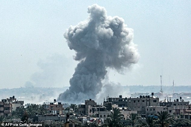 Columns of smoke rise into the sky following an Israeli bombardment in the center of the Gaza Strip.