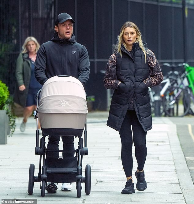 Olly Murs and his wife Amelia enjoyed a stroll with their newborn Madison in London on Friday after their daughter attended her first live show at just two weeks old at the O2 earlier this week.