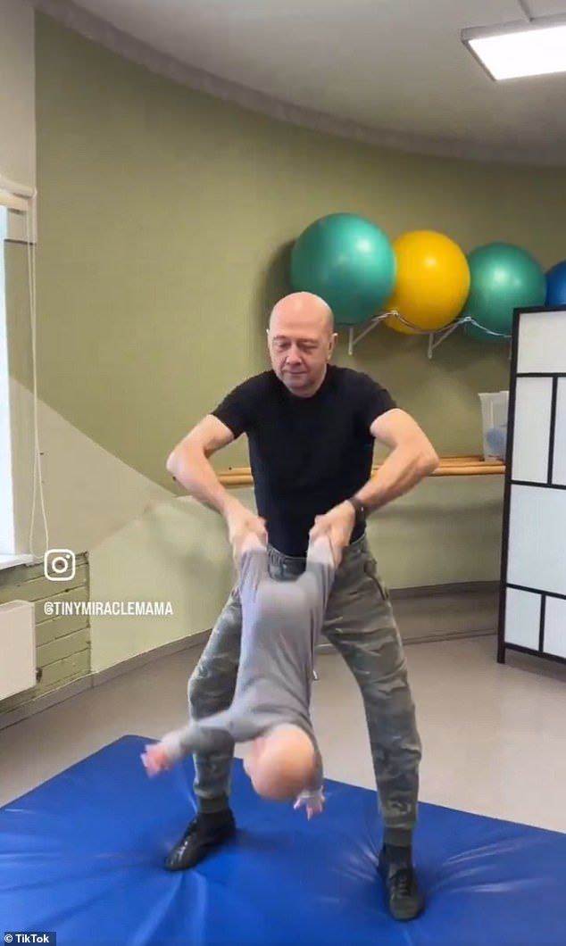 The 35-second video shows the father rocking his baby back and forth, which could cause the baby to dislocate his elbow or suffer shaken baby syndrome.