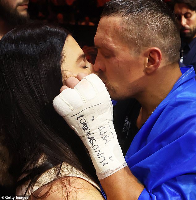 Victory kiss: Oleksandr Usyk kisses his wife, Yekaterina, shares a kiss after the judges deemed him the winner in a close fight against Tyson Fury.