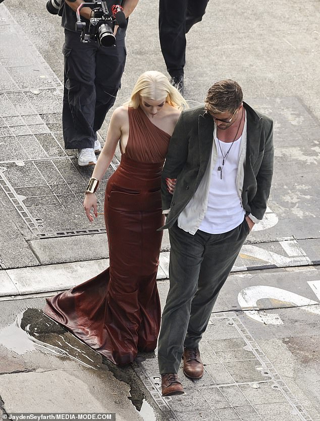 Chris Hemsworth proved chivalry isn't dead as he guided his Furiosa co-star Anya Taylor-Joy through Sydney's rain-soaked CBD during the Australian leg of his press tour on Wednesday.