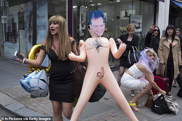 A hen party group is shown posing with an inflatable sex doll, an item that has been banned in the town of Platka d'Aro on the Costa Brava.