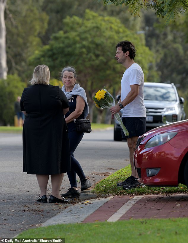 Mourners turned out on the plush street on Saturday, some bringing bouquets of flowers.