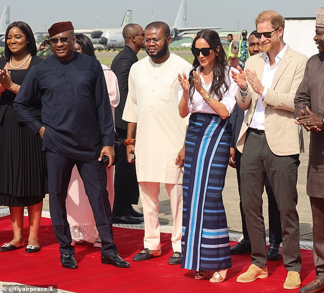 Dr Allen Onyema, founder of Nigerian airline Air Peace, provided the Sussexes with free flights during their three-day tour of Nigeria to celebrate 10 years of Harry's Invictus Games (left in navy blue).