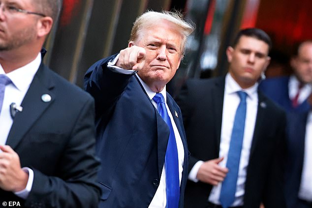 Trump gestures to the media and crowd outside Trump Tower after a jury found him guilty of all 34 counts in his criminal trial.