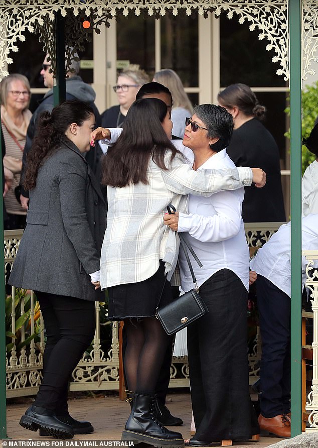 Mourners comforted each other after the brief service.