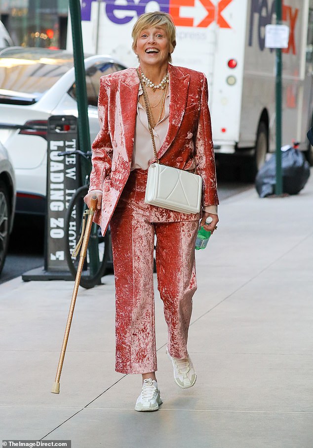 Sharon Stone looked gorgeous in a crinkled coral velvet suit as she walked with the help of a cane in New York City.