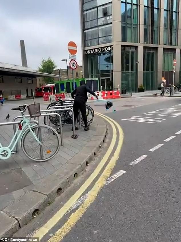 A young man dressed all in black, with his hood up and a PPE mask hiding his face, was filmed stealing a bicycle this morning in south London.