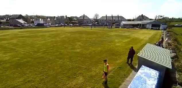 The images show the linesman and the figure of the Amlwch staff crossing each other on the touchline in the first half.