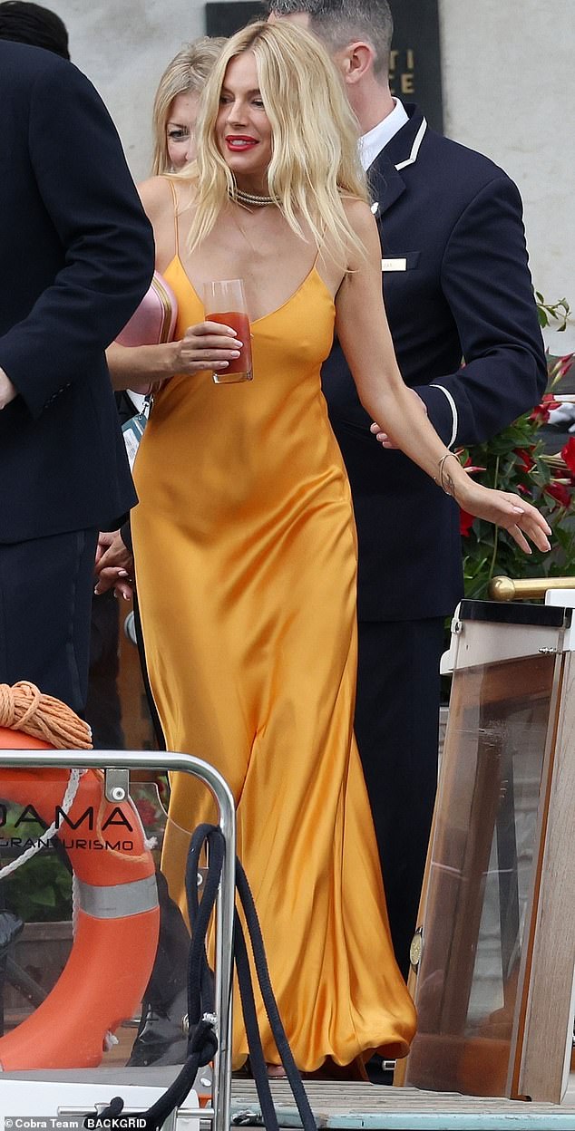 The actress, who welcomed her second child, and first with Oli, in January, a daughter whose name has not been revealed, went braless under a low-cut burnt orange dress for the occasion.