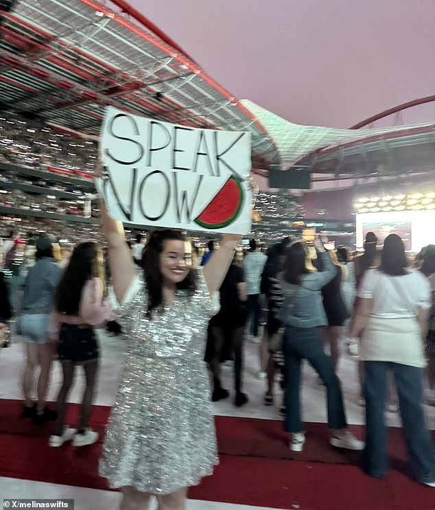 A concert goer in a sparkly dress held a sign that said 