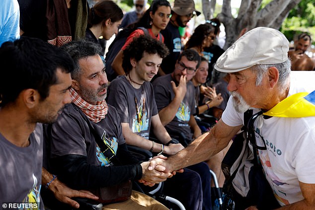 A man greets people on hunger strike during a demonstration for a change in the tourism model in the Canary Islands, in Santa Cruz de Tenerife, Spain, on April 20, 2024.