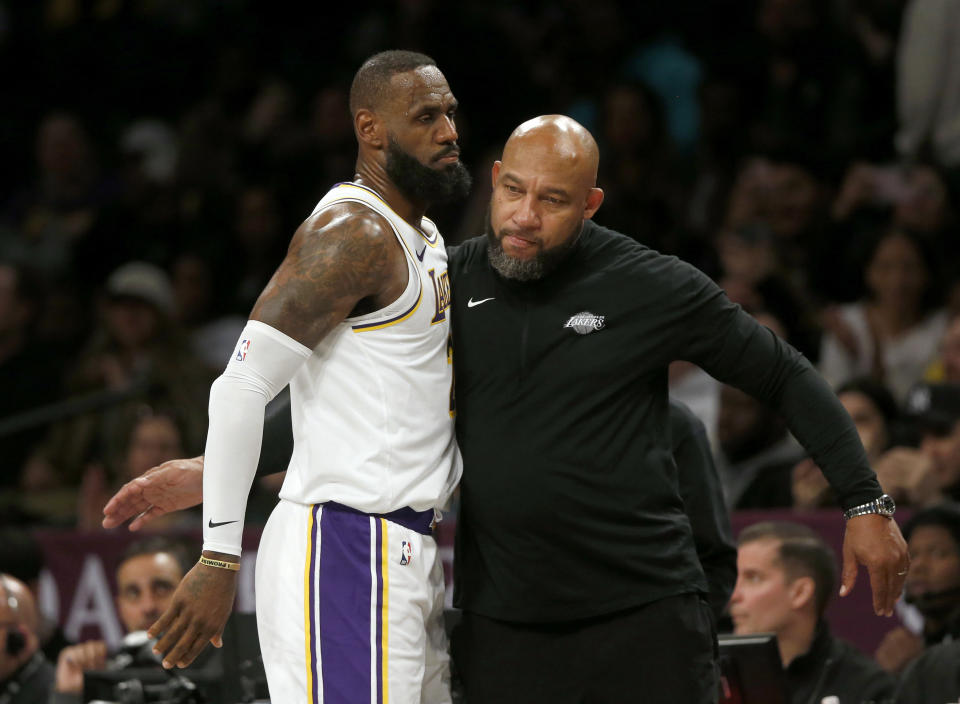 Los Angeles Lakers head coach Darvin Ham, right, congratulates forward LeBron James during the second half of the team's NBA basketball game against the Brooklyn Nets on Sunday, March 31, 2024, in New York.  (AP Photo/John Munson)