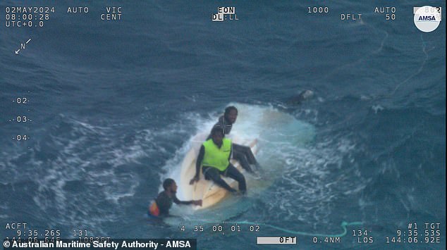 Three men have been rescued from a capsized tinnie that was adrift about 200 kilometers off the coast of Australia.