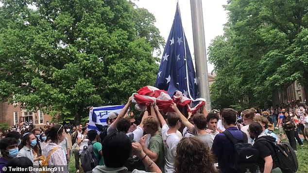 Footage emerged on social media showing the group of male students clinging to the Stars and Stripes during a protest on Tuesday.