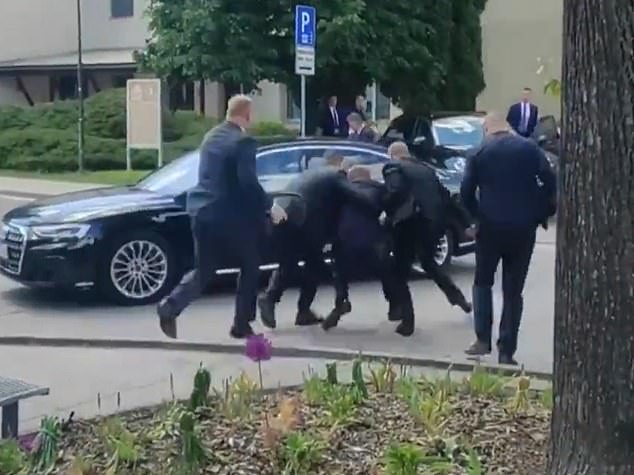 Robert Fico (center of photo) being carried by security officers to a car after being shot in Handlova, northeast of Bratislava, following a Slovak government meeting.