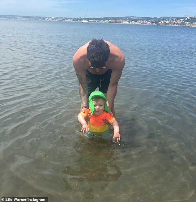 Continuing to capture sweet moments from their vacation, Nat is seen helping Ezra slowly enter the water.