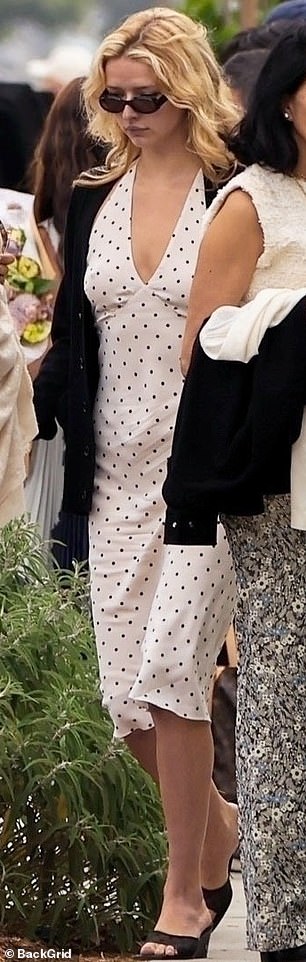 Apple cut an elegant figure in a white polka dot dress that emphasized her lithe figure.