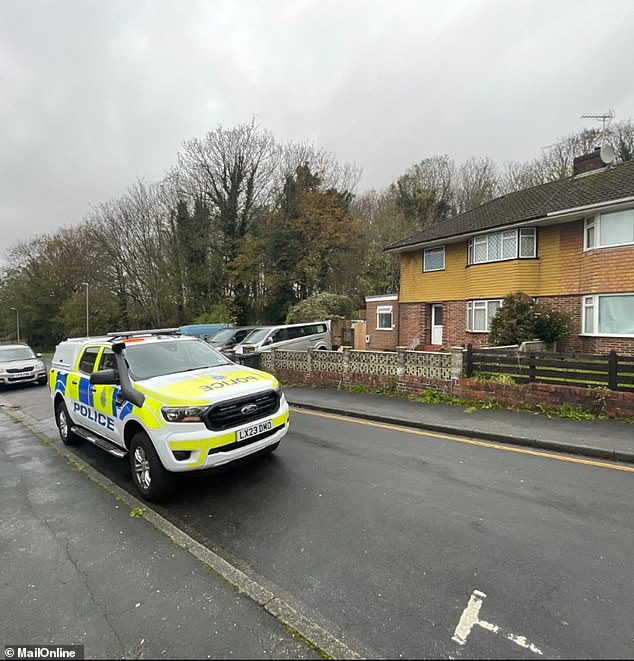 A police car is pictured outside Luke Cobb's home in Brighton. He received a community order for 12 months with 10 RAR days and 200 hours of unpaid work.