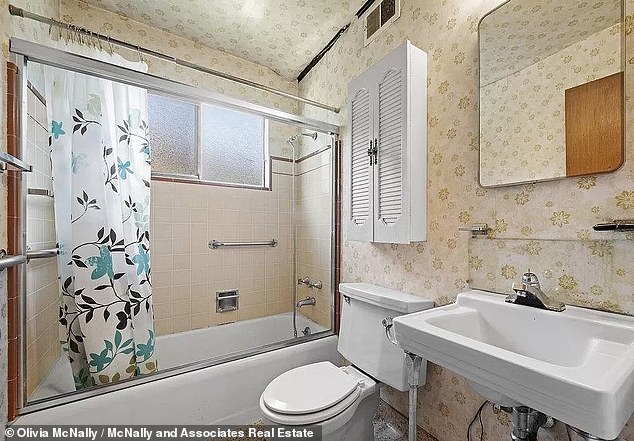 The old house also includes a bathroom with muted yellow wallpaper and vintage amenities.