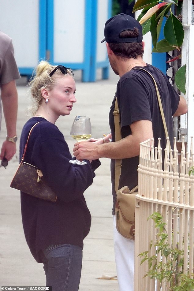 The star took her cigarettes out of her Louis Vuitton bag after the couple enjoyed some shopping in the city.