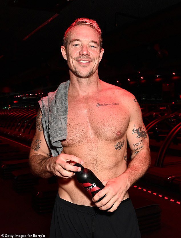 While heading to run on the treadmill, Diplo took off his shirt, showing off his toned abs and multiple tattoos.