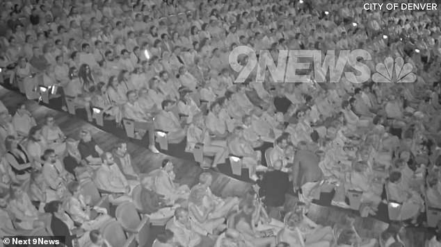 Security personnel are seen speaking with the congresswoman and Gallagher inside the theater before escorting them outside.