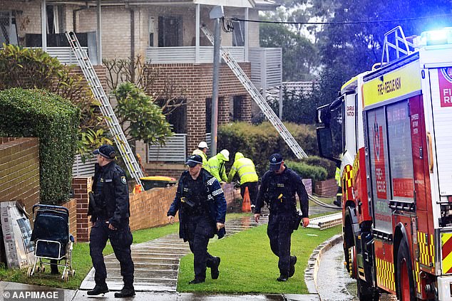 Police closed access to the street and an increased police presence has been observed in the area since 7.30am on Sunday (pictured, police officers at the scene on Saturday)