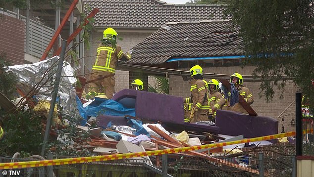 Emergency services (pictured) braved heavy rain and cold and worked through the night in a bid to find the woman trapped beneath the rubble.