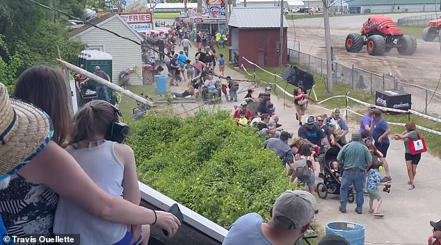 People cringe and duck as the colossal wooden structure crashes to the ground. Then the heavy utility line crashes inches from where the spectators were standing.