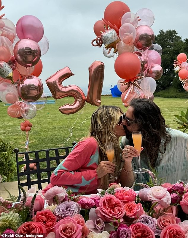 She also uploaded a joyful snap of herself and Tom, the guitarist for German band Tokio Hotel, sharing a romantic kiss as they toasted each other.