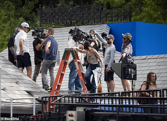 After finishing the scene, she was seen climbing down a ladder to get off the roof.