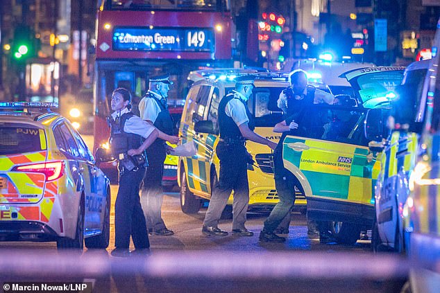 Pictured: Emergency services at the scene in Dalston, east London.