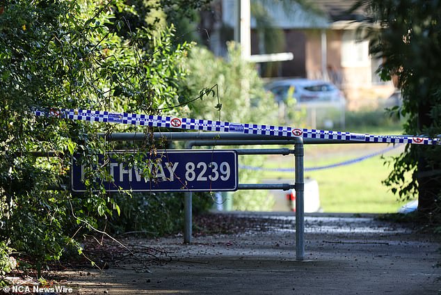 Police announced that the search area is now a crime scene and officers have closed the street (pictured, police tape near the search area)