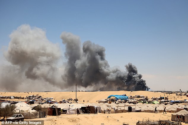 Smoke rises near a makeshift camp for displaced Palestinians in the Tel al-Sultan area of ​​Rafah, southern Gaza Strip, May 30, 2024.