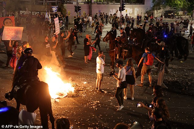 Israeli mounted police attempt to disperse a demonstration by relatives and supporters of Israelis held hostage by Palestinian Hamas militants in Gaza.