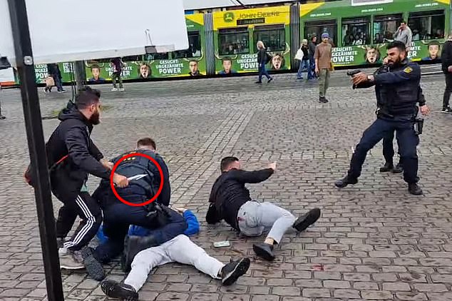 The wild sword is clearly seen in this screenshot from the YouTube live stream as the attack goes to stab the officer in the neck.